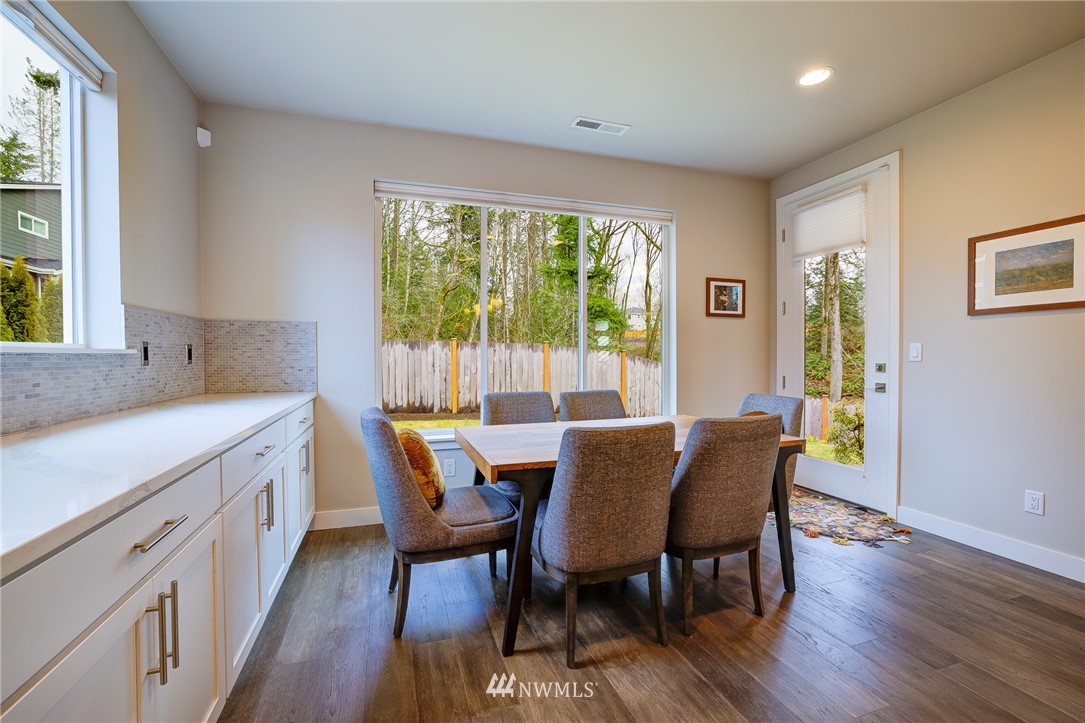 4792 Smithers Avenue South Renton, WA 98055 - Photo 15 of 37 a view of a dining room with furniture and wooden floor