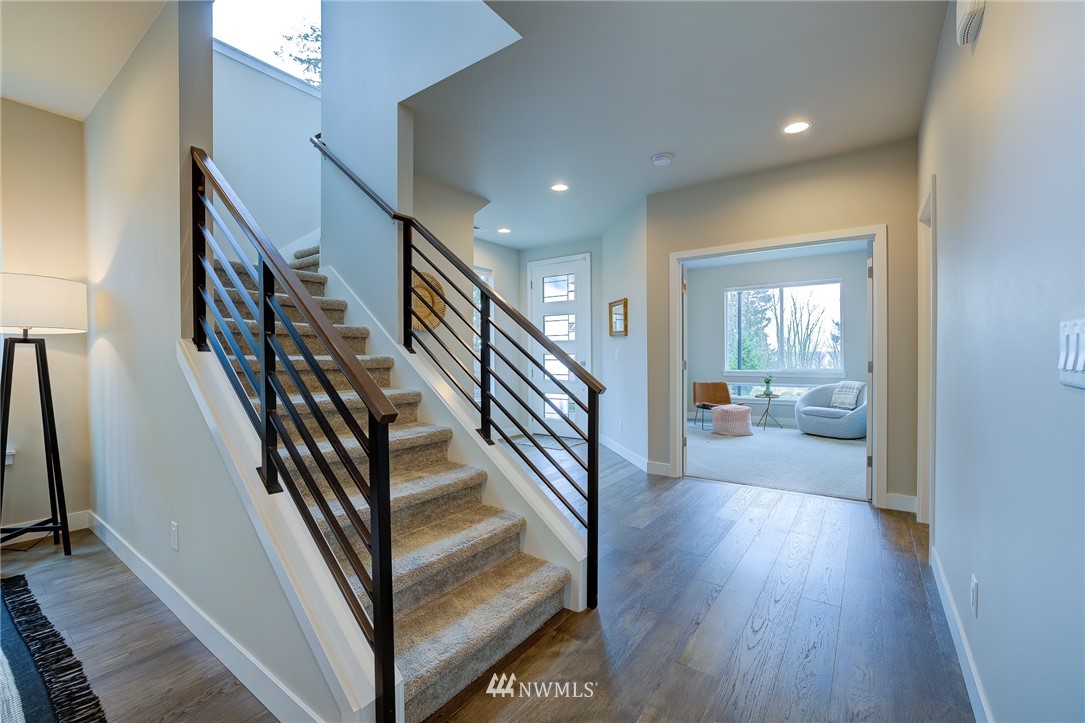 4792 Smithers Avenue South Renton, WA 98055 - Photo 18 of 37 a view of a hallway with wooden floor and staircase