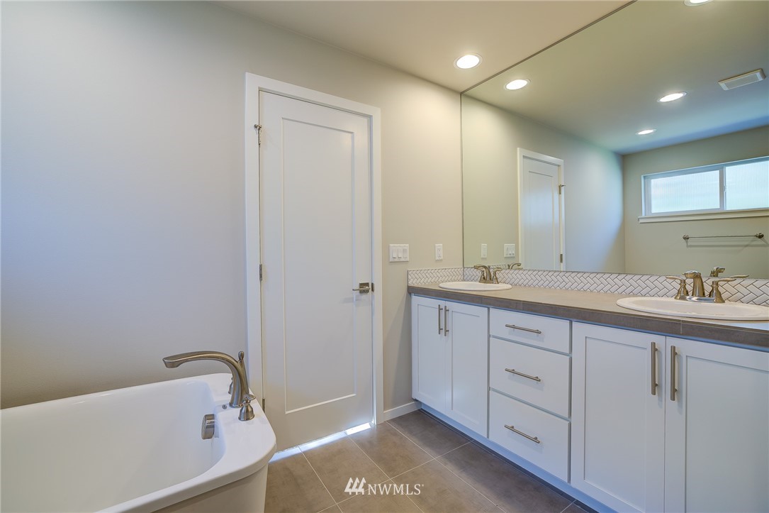 4792 Smithers Avenue South Renton, WA 98055 - Photo 26 of 37 a bathroom with a tub sink and mirror