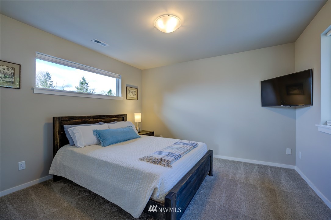 4792 Smithers Avenue South Renton, WA 98055 - Photo 30 of 37 a bedroom with a bed and a flat screen tv