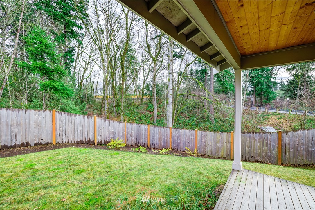 4792 Smithers Avenue South Renton, WA 98055 - Photo 35 of 37 a view of a backyard with wooden fence and large trees