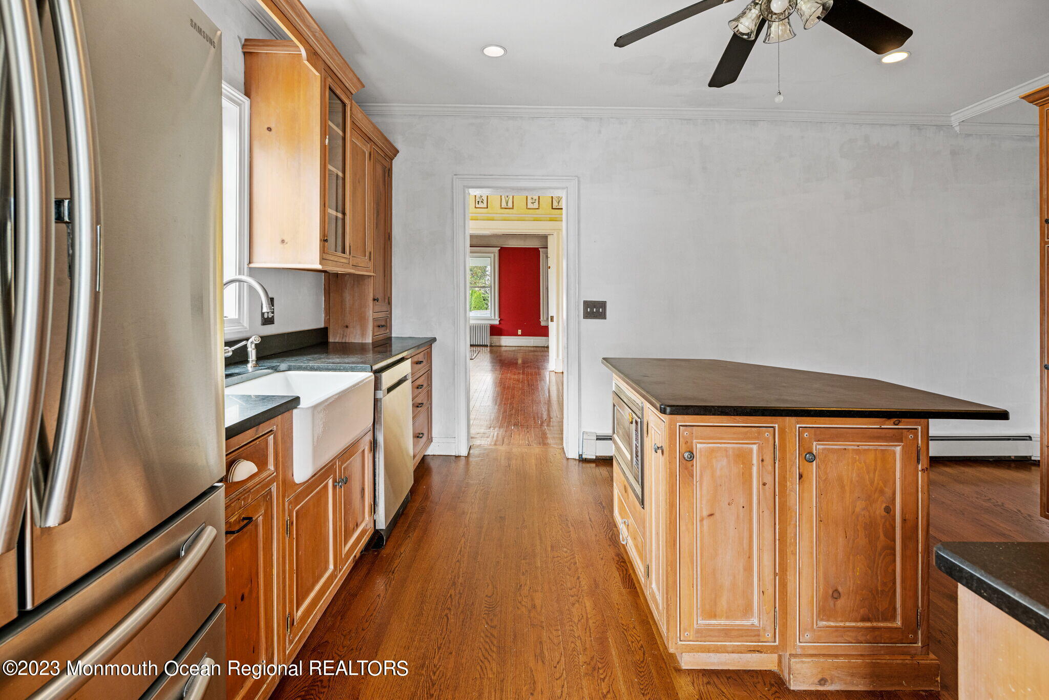 420 River Road Fair Haven, NJ 07704 - Photo 18 of 34 a kitchen with stainless steel appliances a stove top oven a sink a chimney and wooden floor