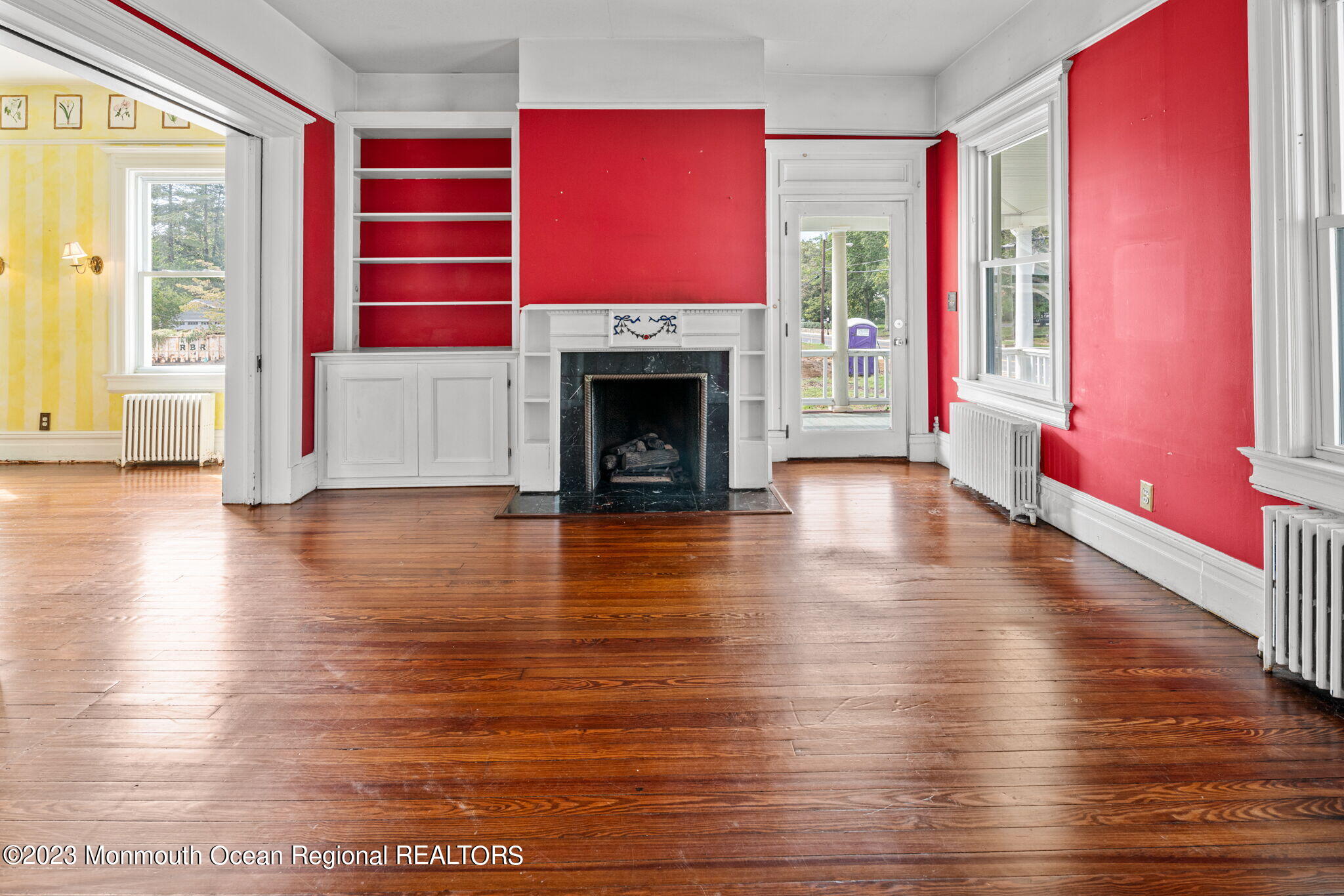 420 River Road Fair Haven, NJ 07704 - Photo 9 of 34 a view of a livingroom with wooden floor a fireplace and windows