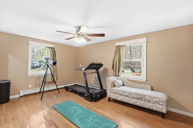 a living room with furniture a clock and a window