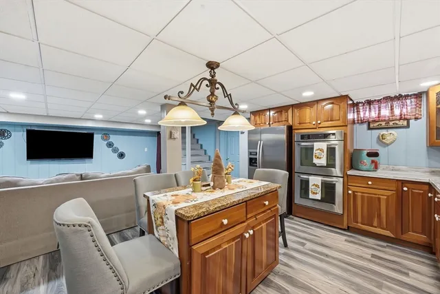 a kitchen with stainless steel appliances kitchen island granite countertop a sink and cabinets