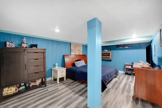 a bedroom with furniture and wooden floor