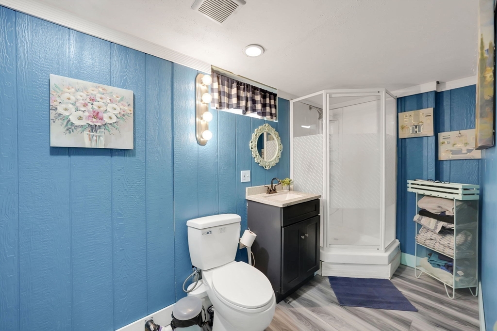 20 Old Orchard Road Wilbraham, MA 01095 - Photo 34 of 40 a white toilet sitting next to a bathroom sink and a mirror