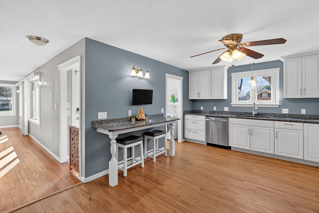20 Old Orchard Road Wilbraham, MA 01095 - Photo 8 of 40 a kitchen with granite countertop a stove a sink dishwasher and a refrigerator with wooden floor