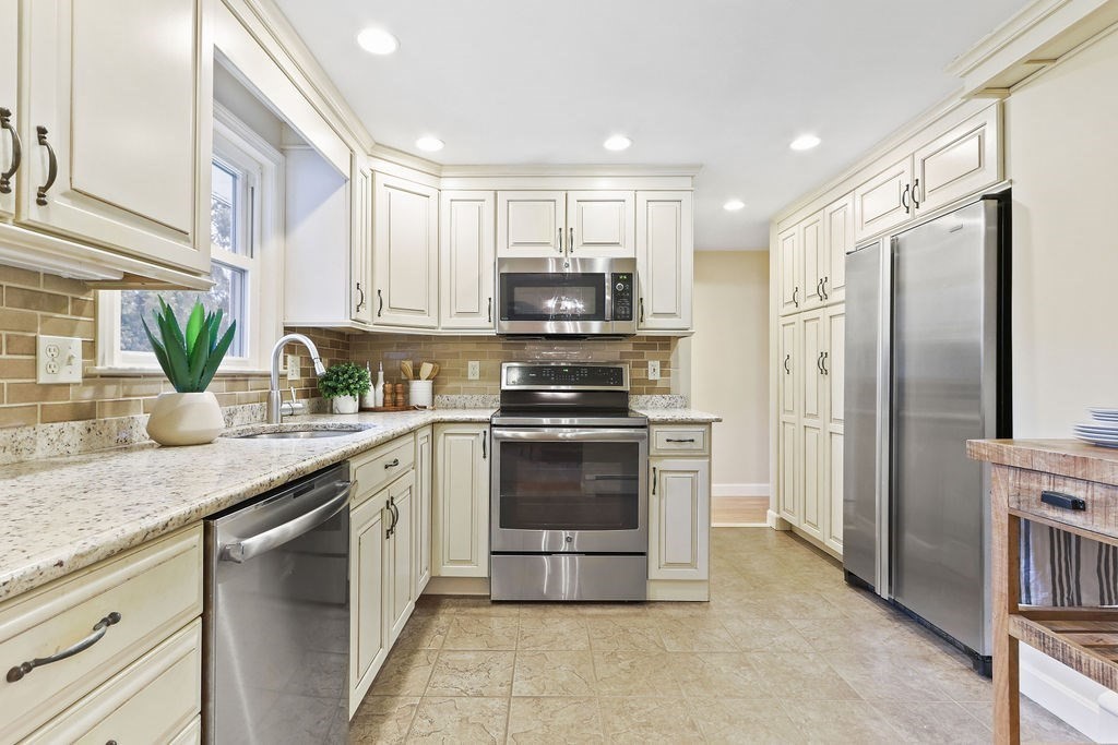 13 Wentworth Road Natick, MA 01760 - Photo 12 of 33 a kitchen with granite countertop a stove a sink and a refrigerator