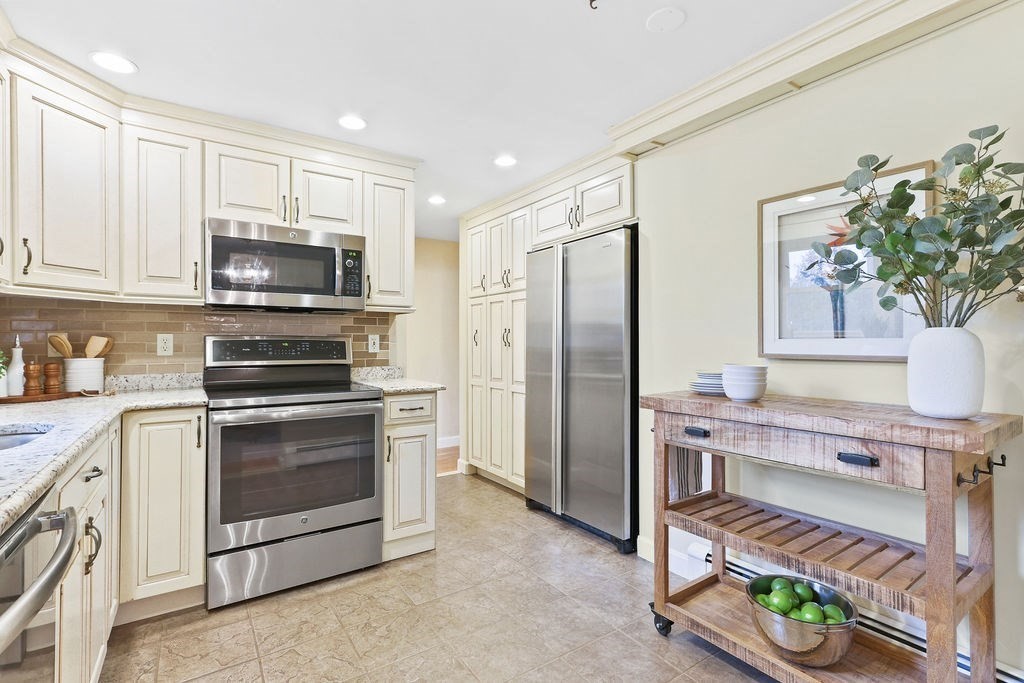 13 Wentworth Road Natick, MA 01760 - Photo 13 of 33 a kitchen with stainless steel appliances a stove a refrigerator and a microwave