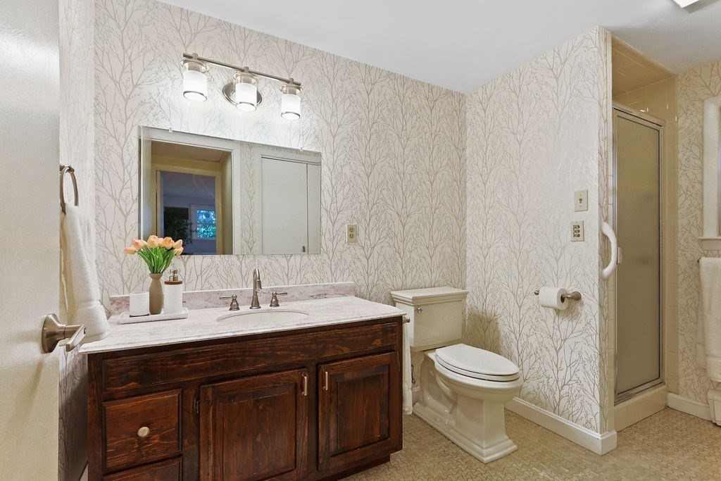 13 Wentworth Road Natick, MA 01760 - Photo 19 of 33 a bathroom with a sink a toilet and shower