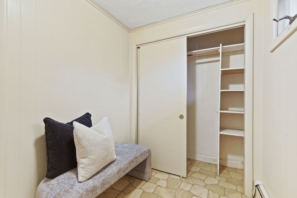 13 Wentworth Road Natick, MA 01760 - Photo 25 of 33 a living room with a couch and a walk in closet with wooden floor