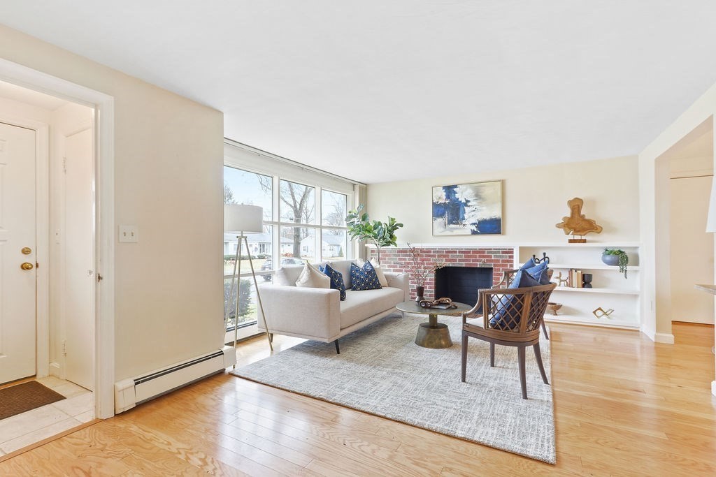 13 Wentworth Road Natick, MA 01760 - Photo 6 of 33 a living room with furniture a fireplace and a large window