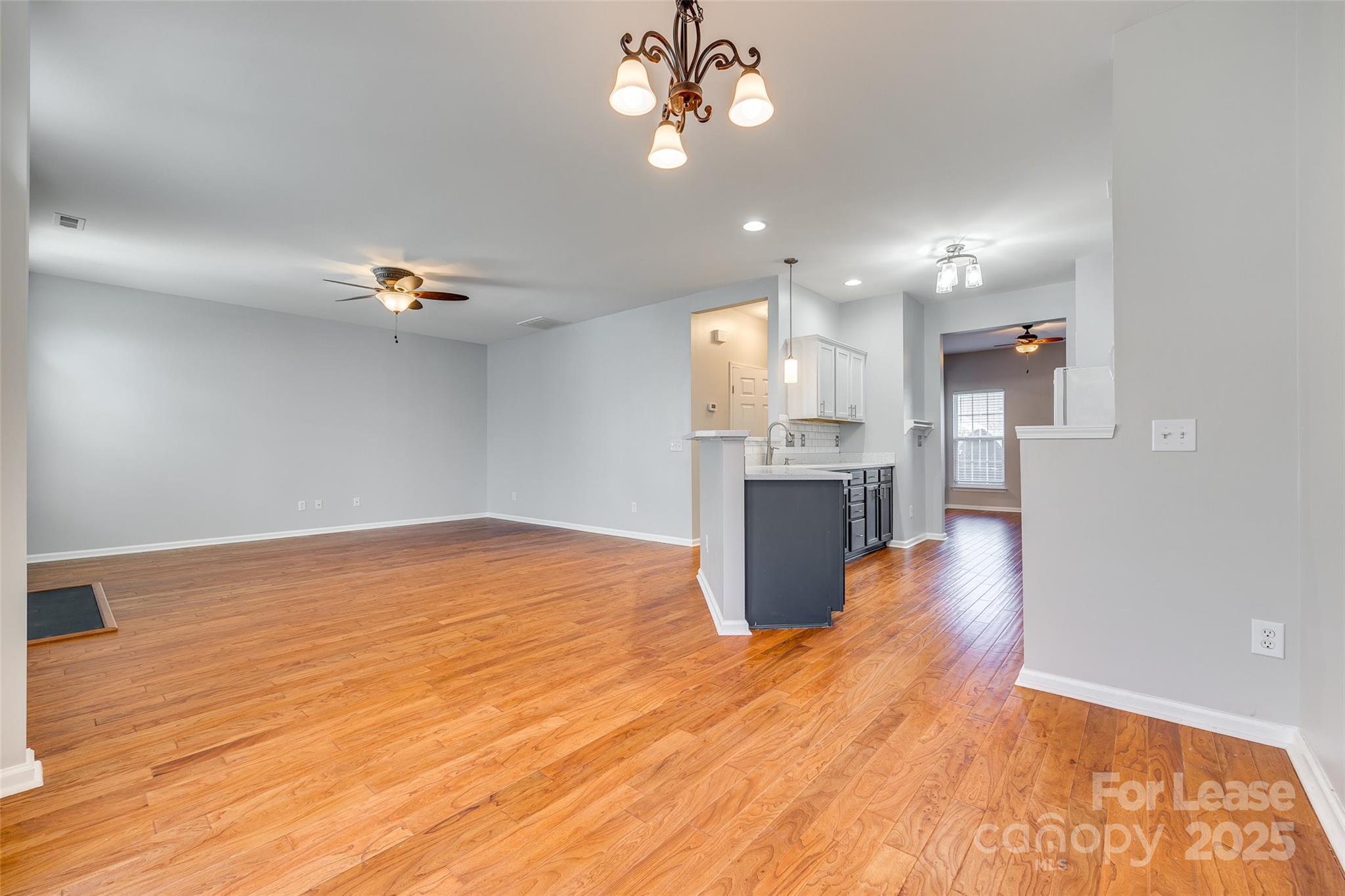 618 Bayou Circle Clover, SC 29710 - Photo 11 of 29 a view of an empty room and kitchen with wooden floor