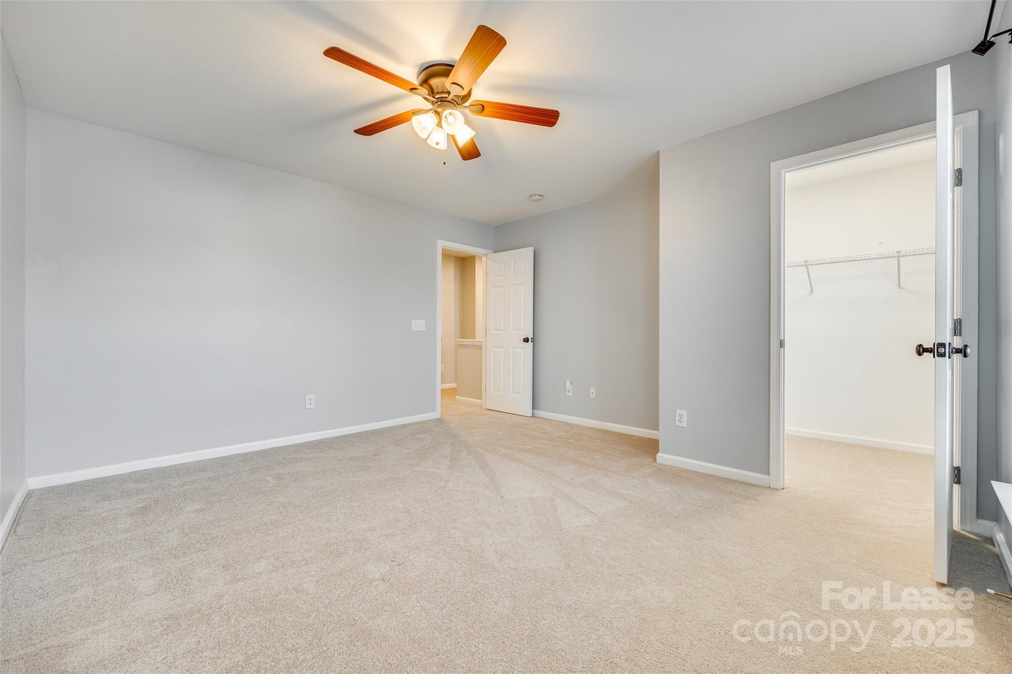 618 Bayou Circle Clover, SC 29710 - Photo 19 of 29 an empty room with a chandelier fan and windows
