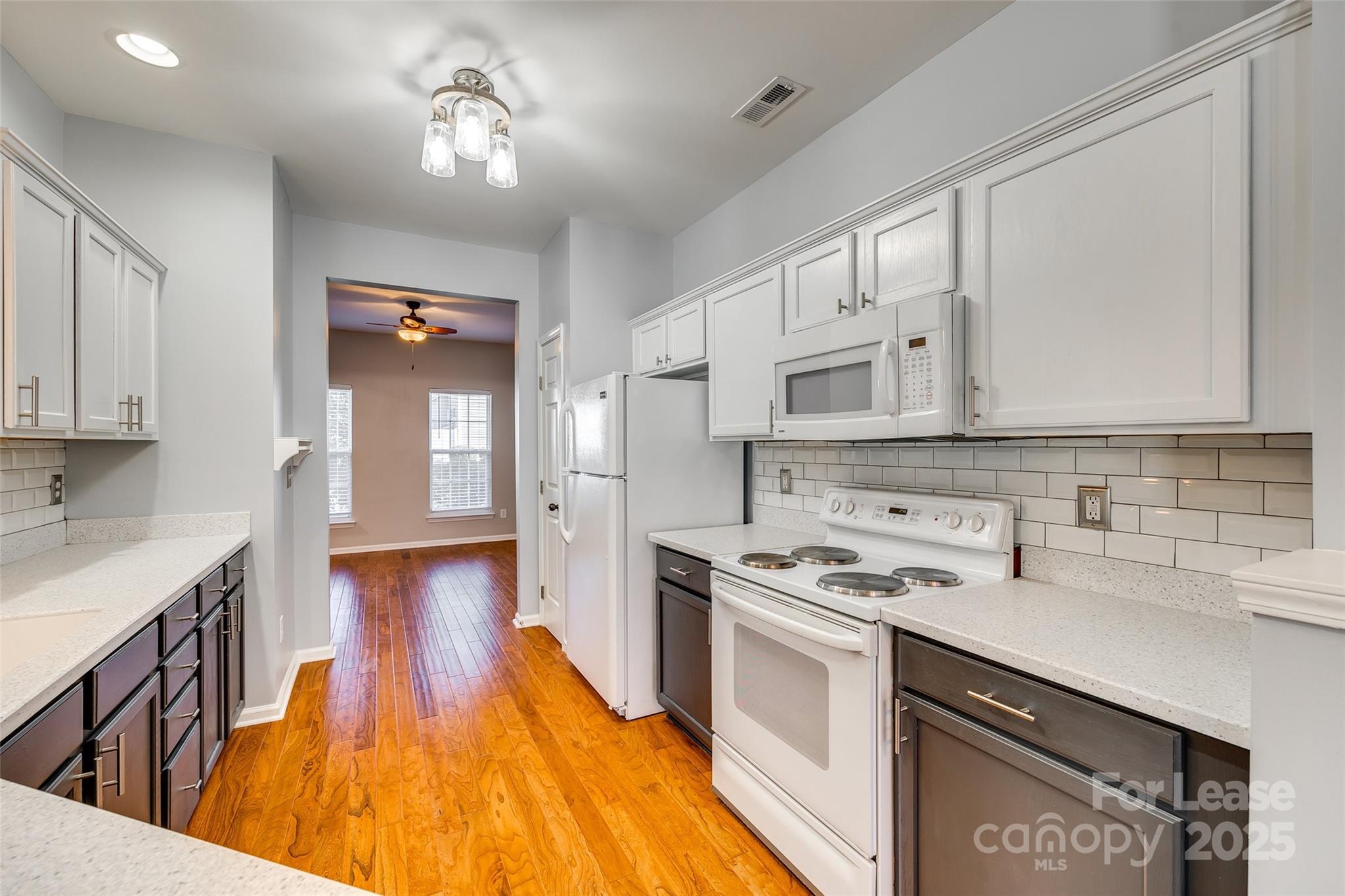 618 Bayou Circle Clover, SC 29710 - Photo 8 of 29 a kitchen that has a lot of cabinets in it and wooden floors