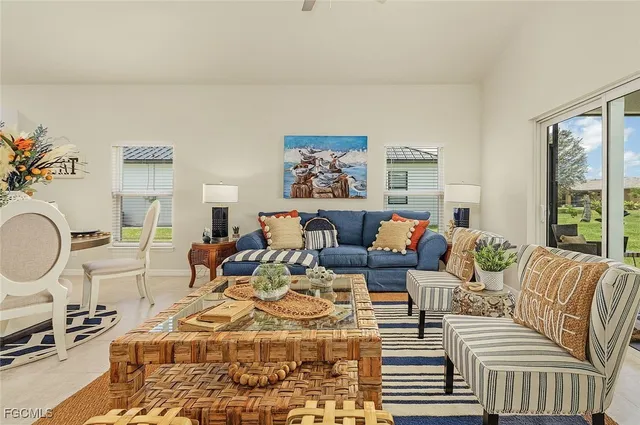 a living room with furniture a rug and a window