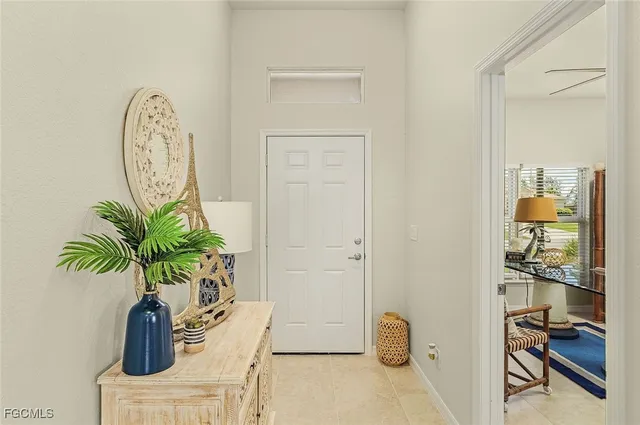 a vase of flowers sitting on a table with a potted plant