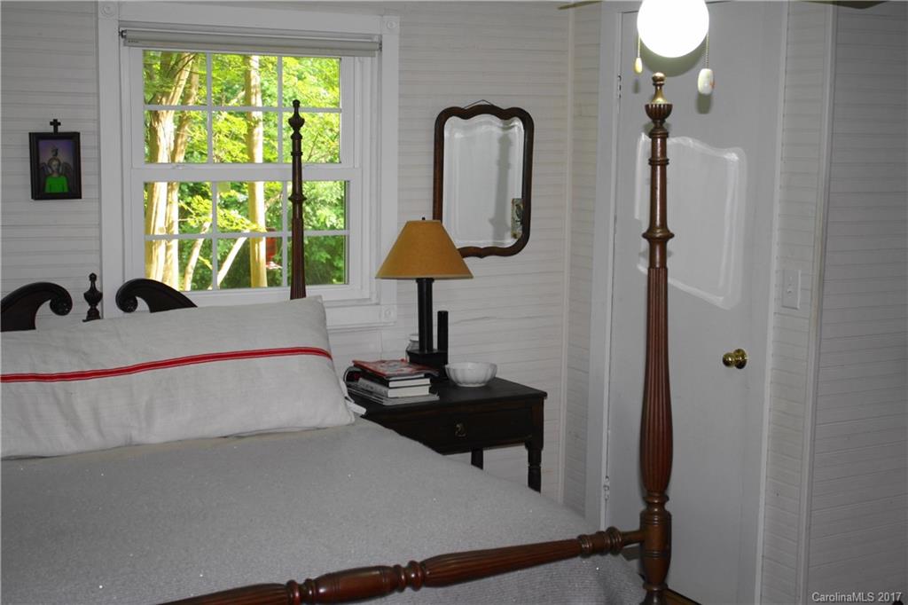 1335 White Oak Road Marshall, NC 28753 - Photo 13 of 24 a bedroom with a bed and a chandelier