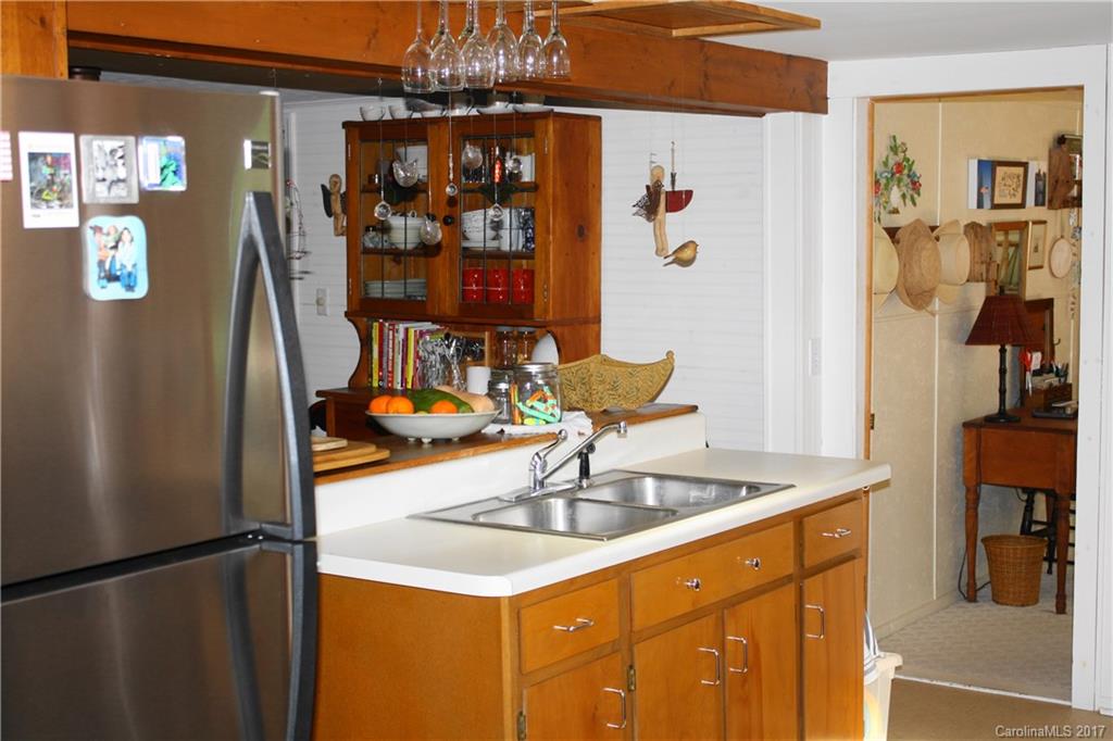 1335 White Oak Road Marshall, NC 28753 - Photo 6 of 24 a kitchen with stainless steel appliances granite countertop a sink and a refrigerator