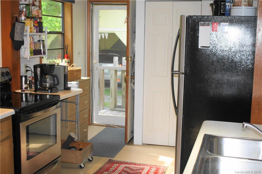 1335 White Oak Road Marshall, NC 28753 - Photo 7 of 24 a kitchen with a sink and refrigerator