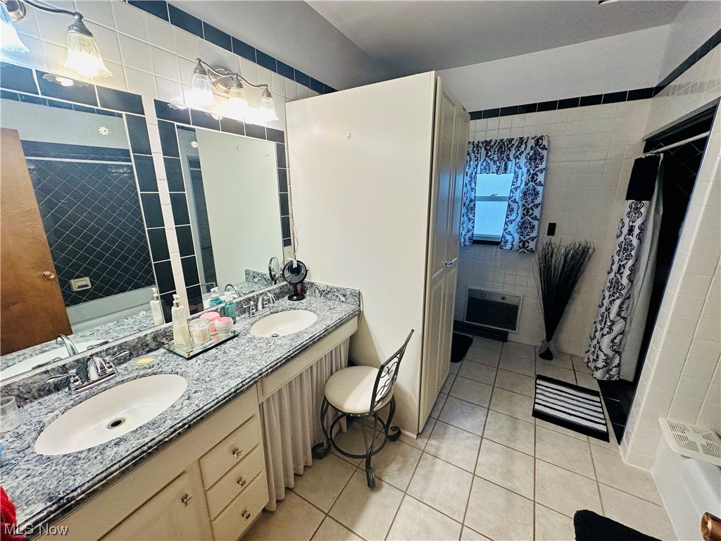 351 Rockdale Road Follansbee, WV 26037 - Photo 14 of 18 Bathroom with tile floors, vanity with extensive cabinet space, double sink, and tile walls