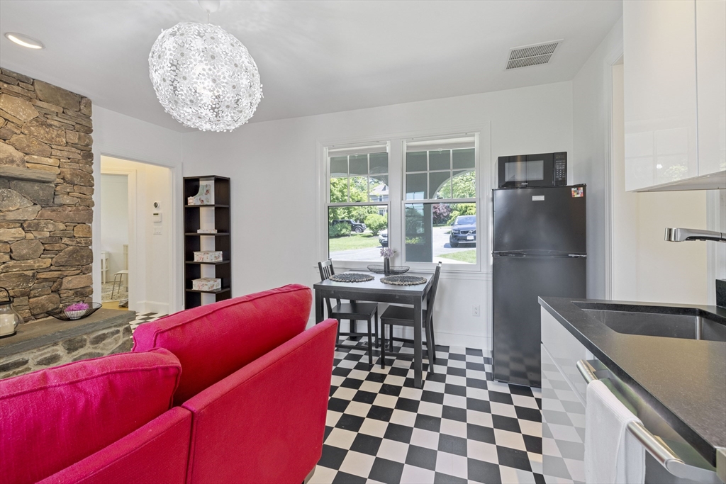 25 Somerset Road, Unit 2 Lexington, MA 02420 - Photo 3 of 17 a kitchen with stainless steel appliances kitchen island granite countertop a refrigerator and a stove top oven
