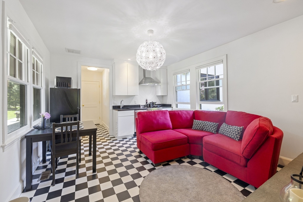 25 Somerset Road, Unit 2 Lexington, MA 02420 - Photo 5 of 17 a living room with furniture a flat screen tv and a dining table