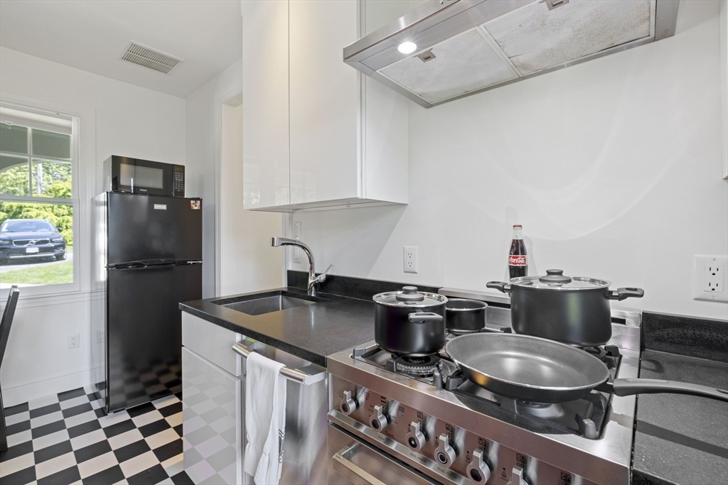 25 Somerset Road, Unit 2 Lexington, MA 02420 - Photo 7 of 17 a kitchen with stainless steel appliances granite countertop a sink stove and refrigerator