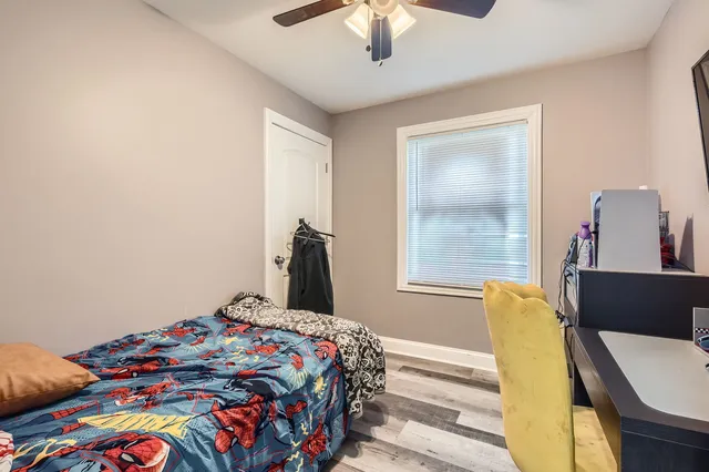 a bedroom with a bed and a chandelier