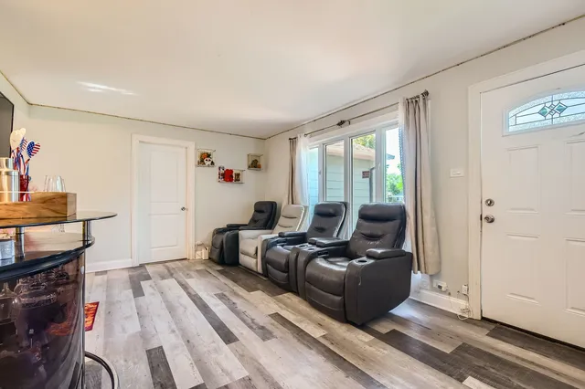 a living room with furniture a flat screen tv and a window