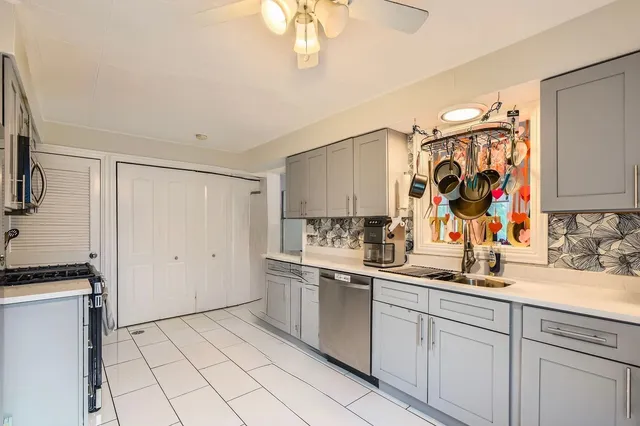 a kitchen with a sink cabinets and stainless steel appliances