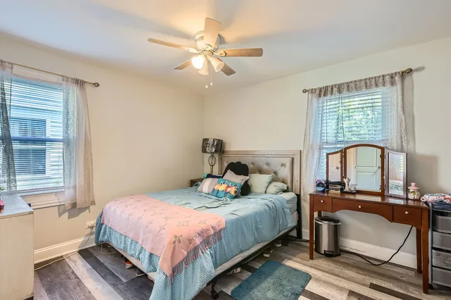 a bedroom with a bed and a large window