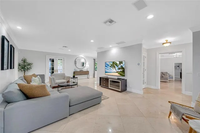 a living room with furniture a couch and a flat screen tv