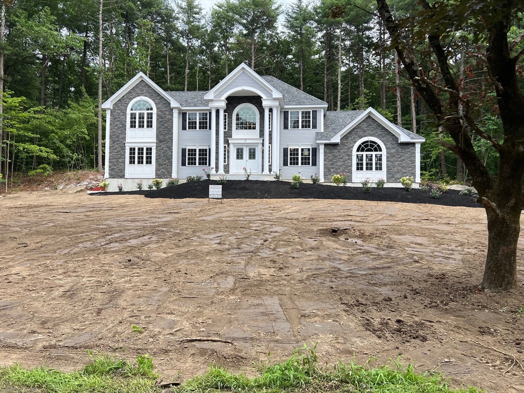 49 Spectacle Hill Road Bolton, MA 01740 - Photo 1 of 42 a front view of a house with yard and green space