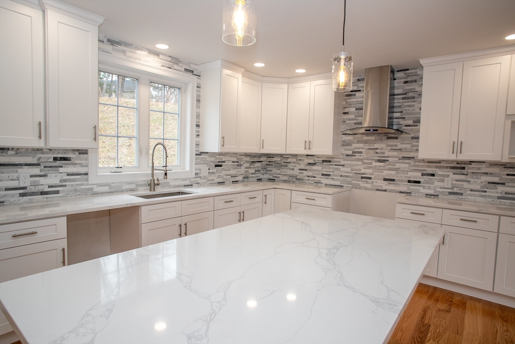 49 Spectacle Hill Road Bolton, MA 01740 - Photo 15 of 42 a large white kitchen with kitchen island granite countertop a sink cabinets and stainless steel appliances