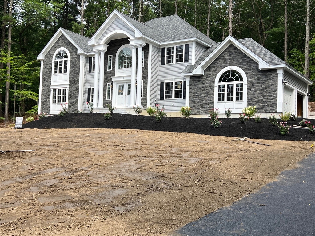 49 Spectacle Hill Road Bolton, MA 01740 - Photo 2 of 42 a front view of a house with a yard