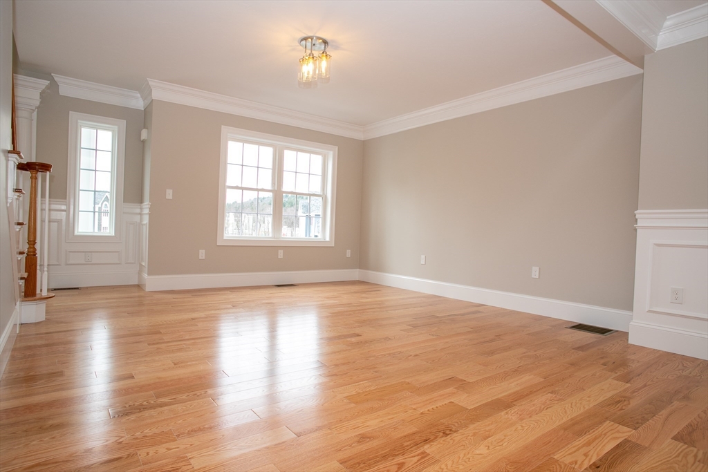 49 Spectacle Hill Road Bolton, MA 01740 - Photo 23 of 42 an empty room with wooden floor and windows