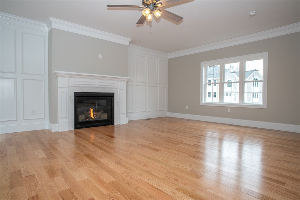 49 Spectacle Hill Road Bolton, MA 01740 - Photo 8 of 42 a view of an empty room with wooden floor fireplace and a window