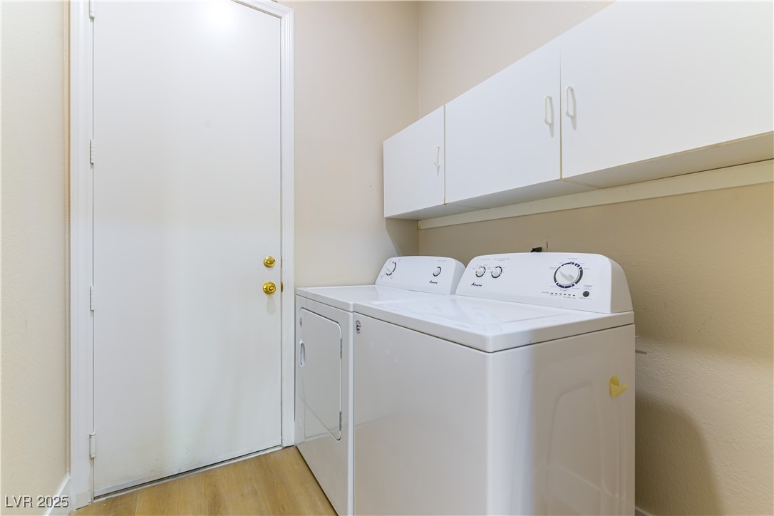 379 Marlin Cove Road Henderson, NV 89012 - Photo 22 of 22 Laundry room featuring separate washer and dryer, cabinet space, and light wood-type flooring