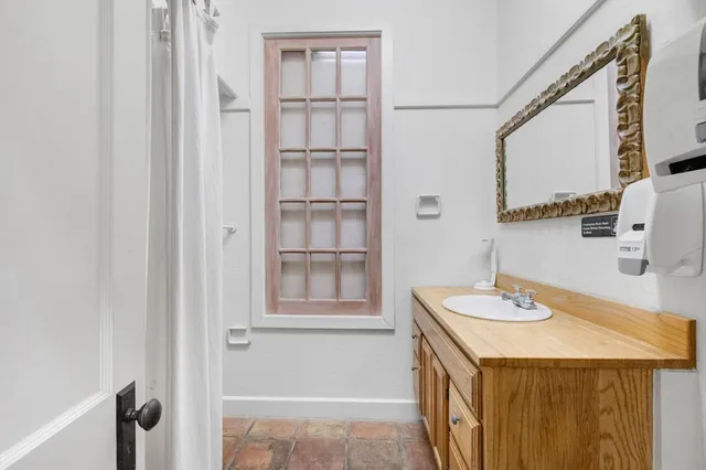 a bathroom with a toilet a sink and mirror