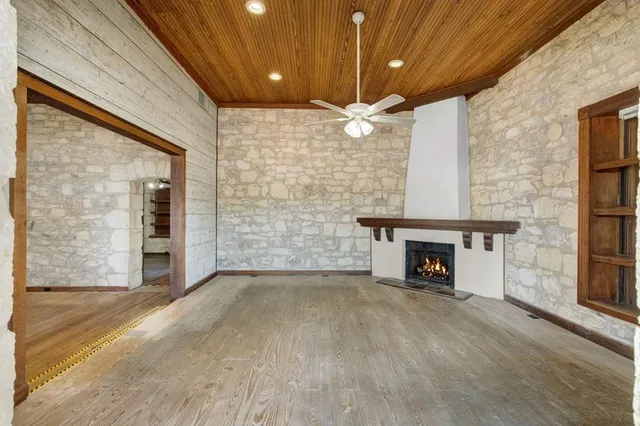 wooden floor in an empty room with a fireplace