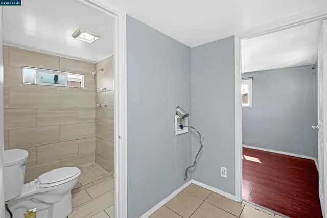 a bathroom with a shower a toilet and sink