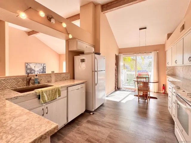 a open kitchen with stainless steel appliances granite countertop a stove and cabinets with wooden floor