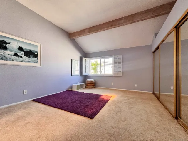 a spacious bedroom with a bed and window
