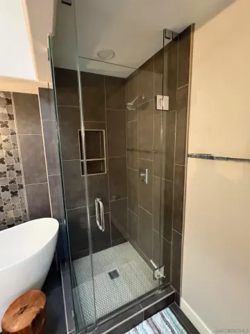 a bathroom with a shower and toilet