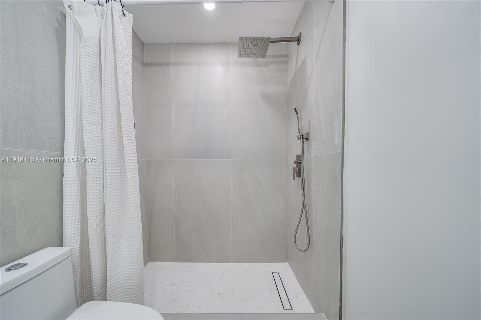 4155 Southwest 66th Terrace, Unit 104 Davie, FL 33314 - Photo 11 of 25 a bathroom with a glass shower door
