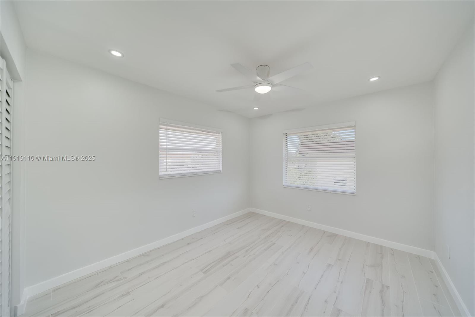 4155 Southwest 66th Terrace, Unit 104 Davie, FL 33314 - Photo 14 of 25 an empty room with wooden floor and windows