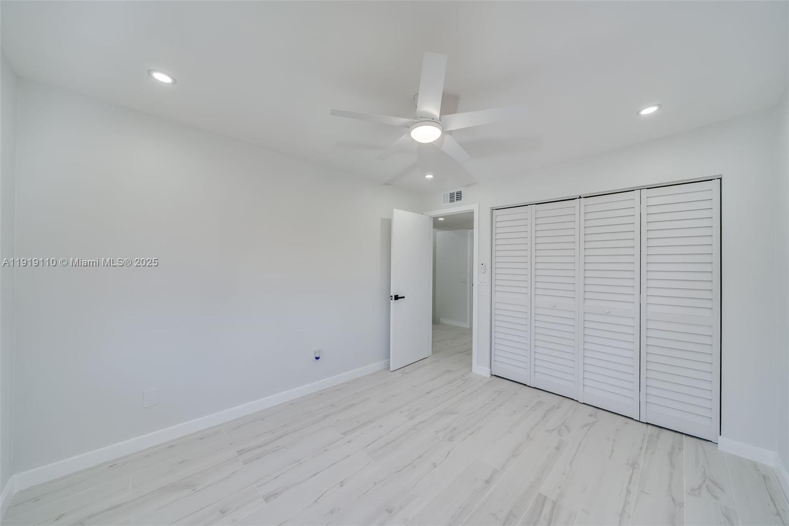 4155 Southwest 66th Terrace, Unit 104 Davie, FL 33314 - Photo 15 of 25 an empty room with wooden floor and closet area