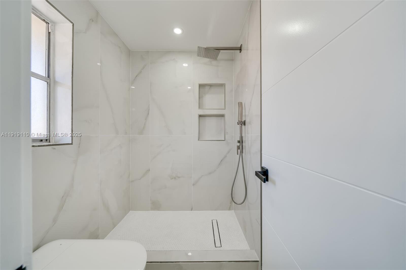 4155 Southwest 66th Terrace, Unit 104 Davie, FL 33314 - Photo 18 of 25 a bathroom with a toilet and a shower